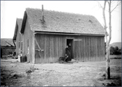Woman in doorway of farmhouse. Courtesy Denver Public Library, Western History Collection, Thomas Michael McKee, Z-1368.