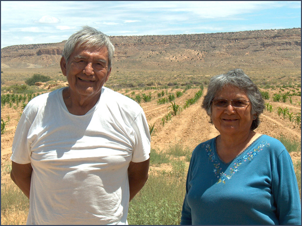 Hopi man and woman with cornfield in background. Photo by Karen R. Adams.