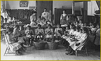 Pueblo girls in sewing class at boarding school.